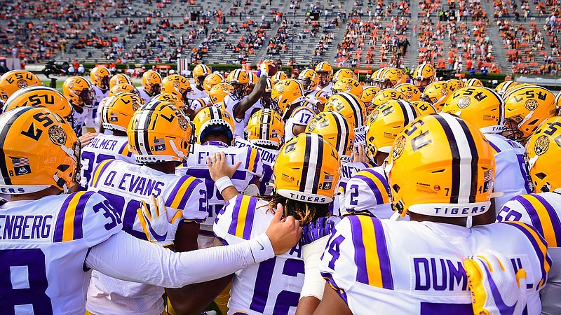 LSU photo by Gus Stark / LSU football players huddle before Saturday's 48-11 loss to Auburn that saddled the reigning national champion with a 2-3 record at the midway mark of its 10-game regular season.