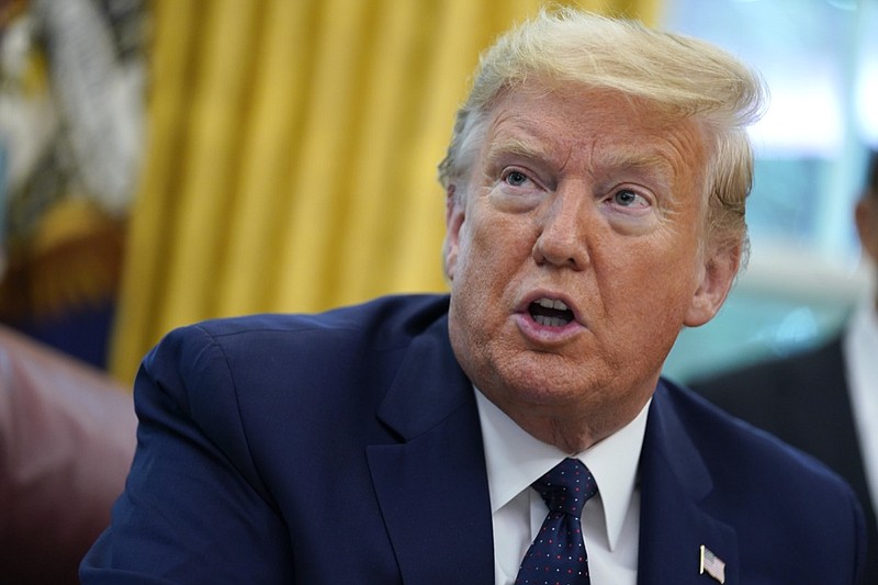 FILE - In this May 28, 2020 file photo, President Donald Trump speaks as he receives a briefing on the 2020 hurricane season in the Oval Office of the White House in Washington. The United States is out of the Paris climate agreement on the day after the presidential election. Experts say the outcome will determine to some degree just how hot and nasty the world will get in the future. The two presidential candidates have stark differences on fighting human-caused climate change. (AP Photo/Evan Vucci, File)