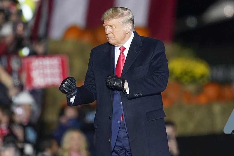 President Donald Trump dances as he leaves a campaign stop, Saturday, Oct. 31, 2020, at the Butler County Regional Airport in Butler, Pa. (AP Photo/Keith Srakocic)