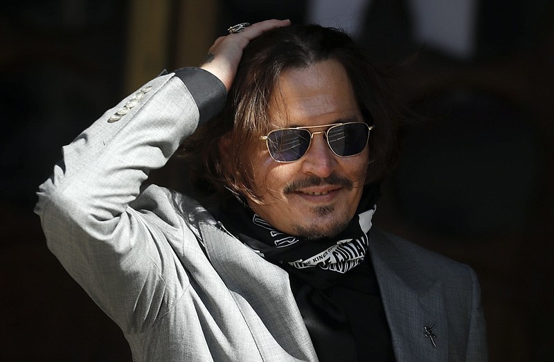 FILE - In this file photo dated Tuesday, July 28, 2020, US Actor Johnny Depp arrives at the High Court in London during his case against News Group Newspapers over a story published about his former wife Amber Heard, which branded him a 'wife beater'. A British judge is set to deliver his judgement in writing on Monday Nov. 2, 2020, deciding whether a tabloid newspaper defamed Depp by calling him a "wife beater." (AP Photo/Frank Augstein, FILE)