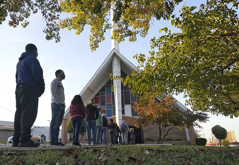 Voters line up outside Vickery Baptist Church waiting to cast their ballots on Election Day Tuesday, Nov. 3, 2020, in Dallas. (AP Photo/LM Otero)