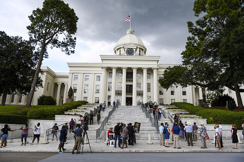 In this July 26, 2020, file photo, mourners gathered at the Alabama Capitol following the death of Rep. John Lewis. Alabama voters will decide whether to remove racist, segregation-era language from the state's 1901 Constitution in the upcoming election. If approved, the measure would go back to legislators and another statewide vote. (AP Photo/Julie Bennett, File)