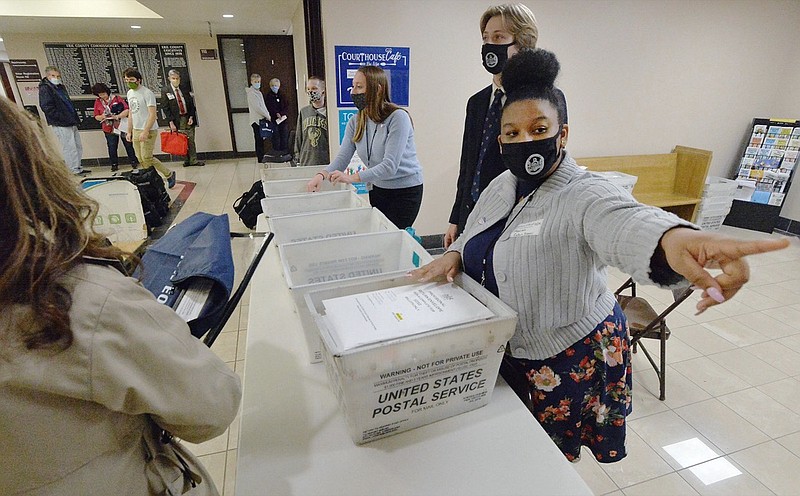 Marian Collin Franco, 20, helps collect provisional ballots at the Erie County Courthouse on Election Day, Tuesday, Nov. 3, 2020, in Erie, Pa. (Greg Wohlford/Erie Times-News via AP)