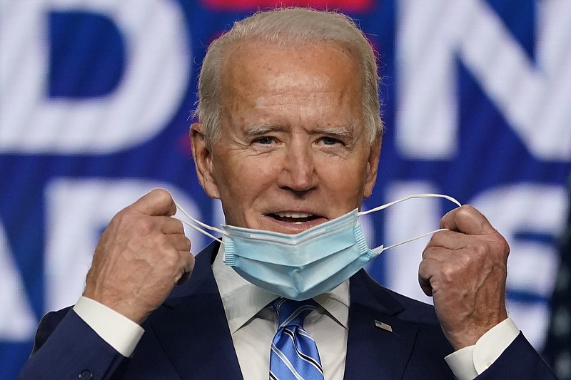 The Associated Press / Democratic presidential candidate and former Vice President Joe Biden takes off his face mask as he prepares to speak Wednesday in Wilmington, Delaware.