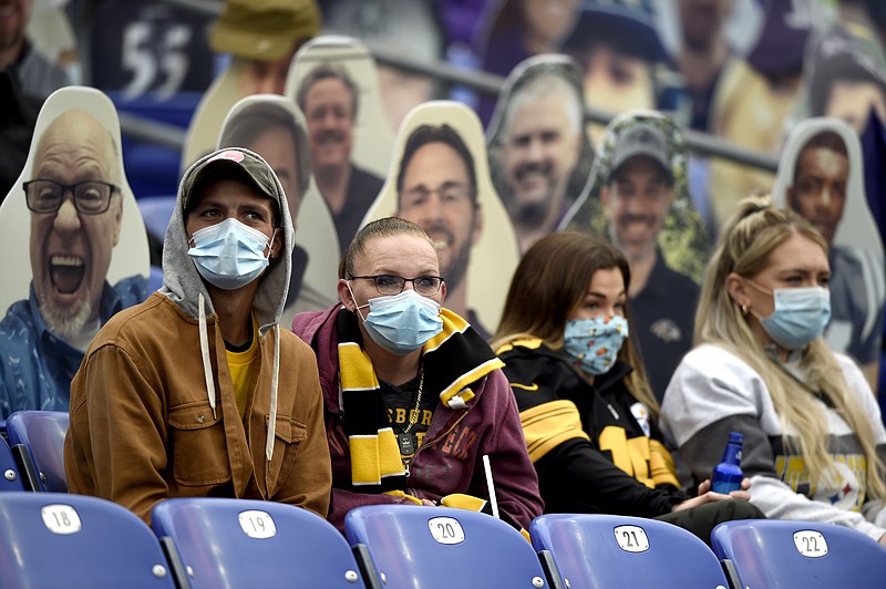 AP photo by Gail Burton / Specators wear face masks to protect against the coronavirus as they watch the Baltimore Ravens host the Pittsburgh Steelers this past Sunday.