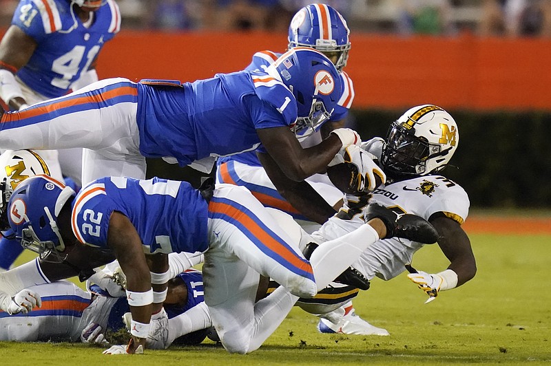 AP photo by John Raoux / Florida linebacker Brenton Cox Jr. (1) helps take down Missouri running back Larry Rountree III during last Saturday's game in Gainesville, Fla. Cox, who played his freshman year at Georgia, transferred and sat out last season, is finally set to face the Bulldogs.