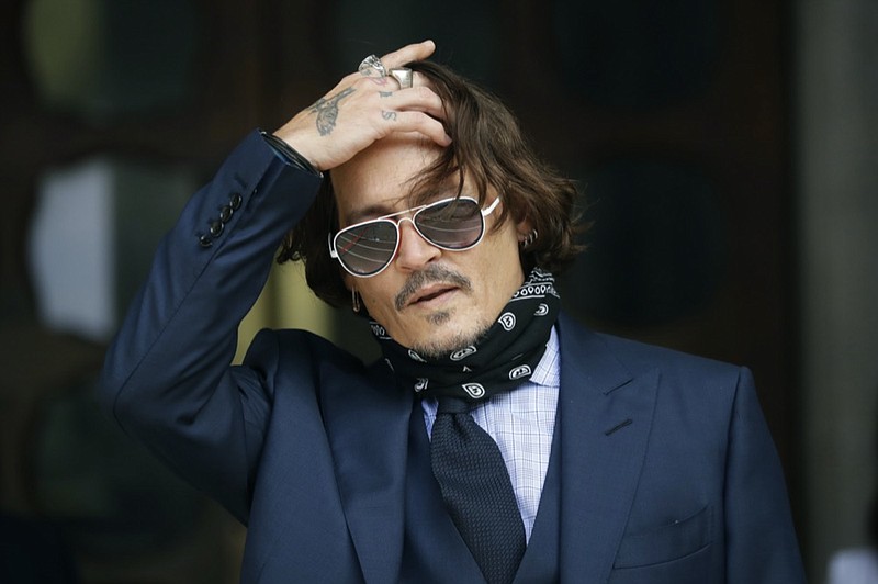 FILE - In this Tuesday, July 14, 2020 file photo, American actor Johnny Depp gestures to the media as he arrives at the High Court in London. (AP Photo/Matt Dunham, file)


