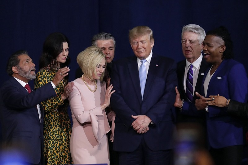 FILE - In this Friday, Jan. 3, 2020 file photo, faith leaders pray with President Donald Trump during a rally for evangelical supporters at the King Jesus International Ministry church in Miami. The conservative evangelical Christians who helped send Trump to the White House four years ago stuck by him again in 2020. (AP Photo/Lynne Sladky)


