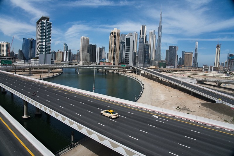 In this April 6, 2020, file photo, a lone taxi cab drives over a highway in front of the Dubai skyline. The United Arab Emirates announced on Saturday a major overhaul of the country's Islamic personal laws, allowing unmarried couples to cohabitate, loosening alcohol restrictions and criminalizing so-called "honor killings." (AP Photo/Jon Gambrel, File)


