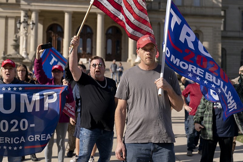 Trump supporters demonstrating the election results face off with counter protesters at the State Capitol in Lansing, Mich., Saturday, Nov. 7, 2020. Democrat Joe Biden defeated President Donald Trump to become the 46th president of the United States on Saturday, positioning himself to lead a nation gripped by the historic pandemic and a confluence of economic and social turmoil. (AP Photo/David Goldman)

