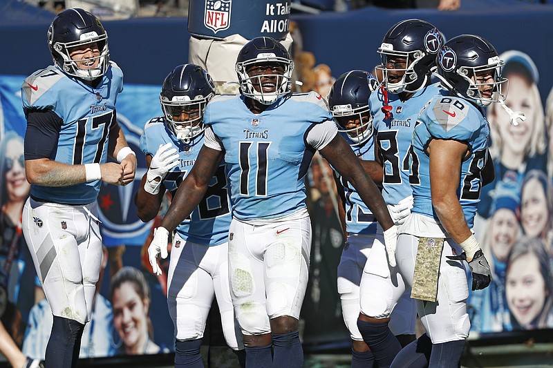 AP photo by Wade Payne / Tennessee Titans wide receiver A.J. Brown (11) celebrates with quarterback Ryan Tannehill, left, after they teamed up for a 40-yard touchdown in the first half of Sunday's game against the Chicago Bears in Nashville.