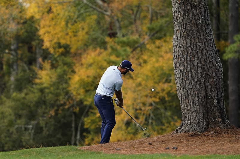 Dustin Johnson hits out of the rough on the third fairway during a practice round for the Masters golf tournament Monday, Nov. 9, 2020, in Augusta, Ga. (AP Photo/Matt Slocum)