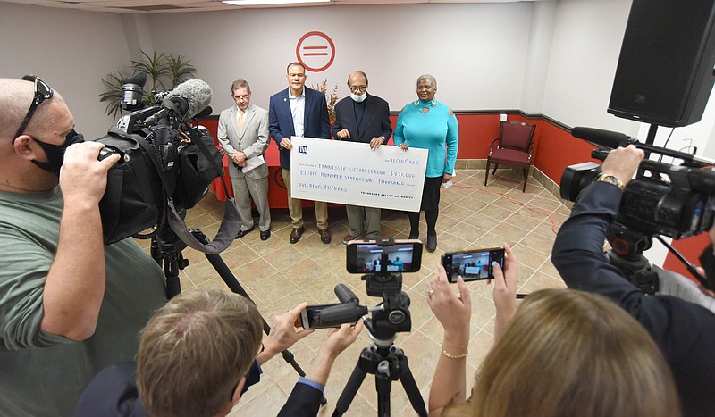 Staff Photo by Matt Hamilton / From left, Albert Waterhouse, Allen Clare, Warren E. Logan, Jr. and Jackie Gilliam hold a check during a press conference at the Urban League office on Tuesday, Nov. 10, 2020.