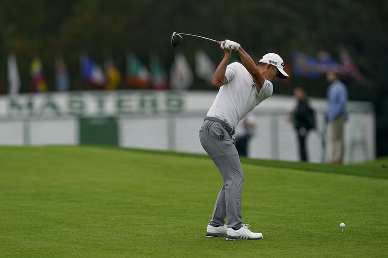 Collin Morikawa hits his tee shot on the first hole during a practice round at the Masters golf tournament Wednesday, Nov. 11, 2020, in Augusta, Ga. (AP Photo/David J. Phillip)