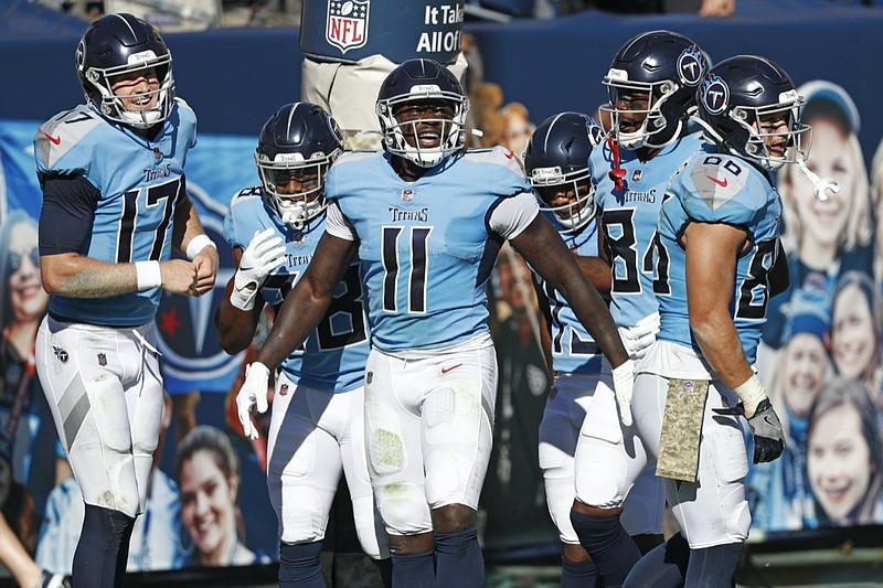 Tennessee Titans wide receiver A.J. Brown (11) celebrates with quarterback Ryan Tannehill (17) after they teamed up for a 40-yard touchdown pass against the Chicago Bears in the first half of an NFL football game Sunday, Nov. 8, 2020, in Nashville, Tenn. (AP Photo/Wade Payne)