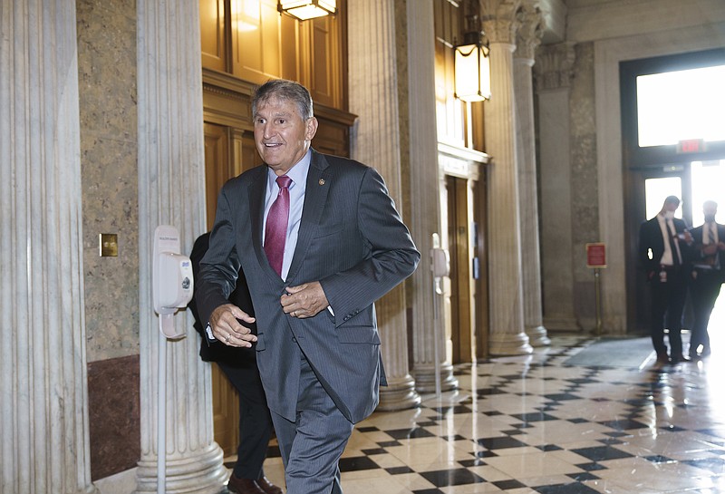 Photo by J. Scott Applewhite of The Associated Press / Sen. Joe Manchin, D-West Virginia, rushes into the Senate chambers on Capitol Hill in Washington on Friday, Oct. 23, 2020.