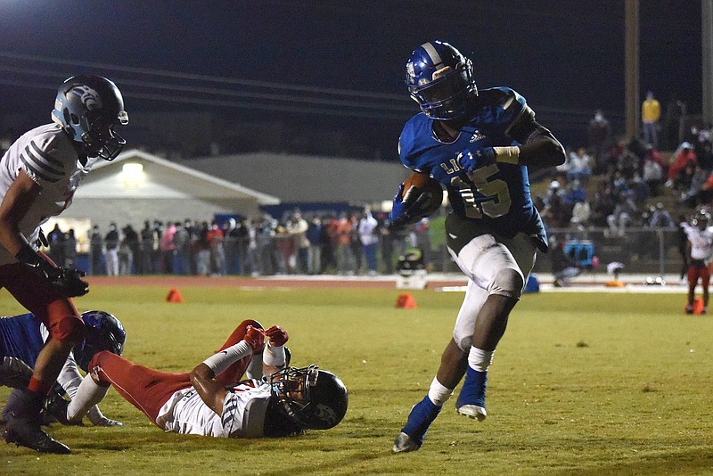 Staff photo by Matt Hamilton / Red Bank running back Lumiere Strickland (15) brushes off a Brainerd defender and scores a touchdown during Friday night's TSSAA Class 3A playoff game at Red Bank. Strickland rushed for 163 yards in the game to help the Lions win 31-12 and advance to a quarterfinal next week against visiting Loudon.