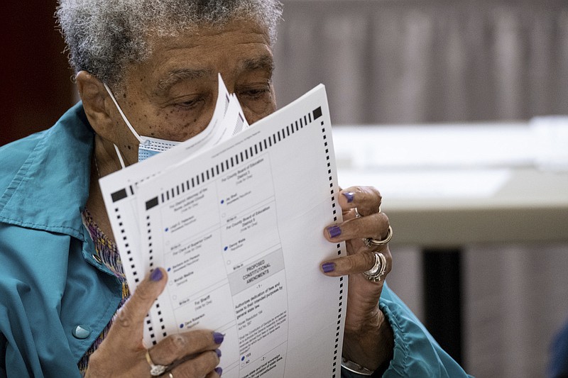 An official sorts ballots during an audit at the Floyd County administration building in Rome, Ga., on Friday morning, Nov. 13, 2020. (AP Photo/Ben Gray)