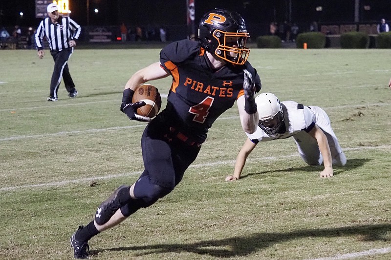Staff photo by C.B. Schmelter / South Pittsburg senior running back Hunter Frame carries the ball as he leaves a Monterey defender behind during a TSSAA Class 1A second-round playoff game Friday night in South Pittsburg, Tenn.