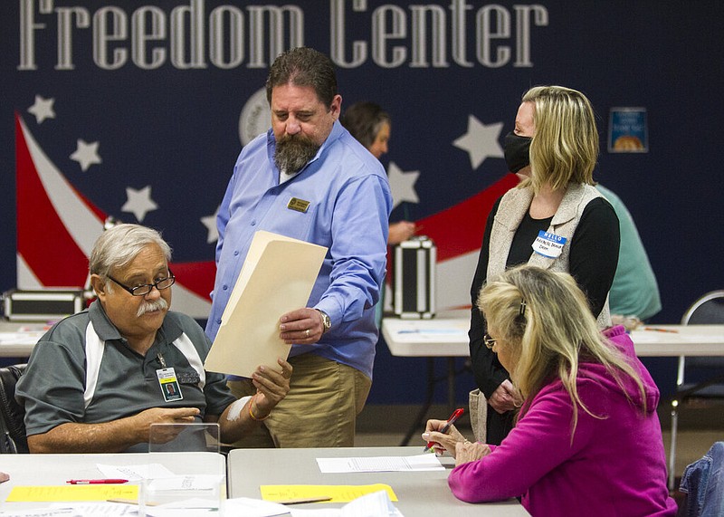 Catoosa County Board of Elections member Rickey Kittle hands a reviewed ballot to Catoosa County Board of Elections member Phil Langston during the first day of recounts for the 2020 election at the Catoosa County Elections office on Friday, Nov. 13, 2020, in Ringgold, Ga. (Troy Stolt/Chattanooga Times Free Press)