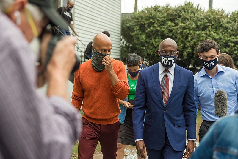 FILE -- From left: The rapper Common with Democratic candidates for U.S. Senate, Raphael Warnock and Jon Ossoff, in Atlanta, Oct. 27, 2020. The special elections were devised by white Republicans to dilute the power of Black voters. But those involved in earlier contests say demographic change and Democratic energy could allow the party to finally beat the odds. (Lynsey Weatherspoon/The New York Times)