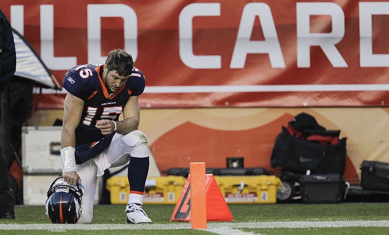 AP photo by Joe Mahoney / Denver Broncos quarterback Tim Tebow kneels on the sidelines during the third quarter of an NFL wild-card playoff game against the visiting Pittsburgh Steelers on Jan. 8, 2012.
