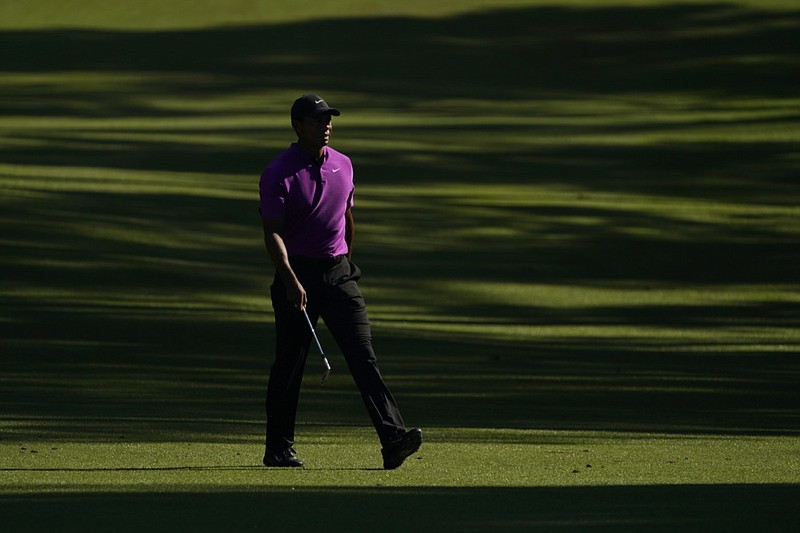 AP photo by David J. Phillip / Tiger Woods walks on the 13th fairway at Augusta National Golf Club during the third round of the Masters on Saturday.