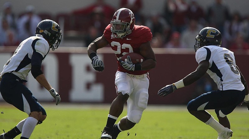 Crimson Tide photos / Alabama running back Mark Ingram looks to elude University of Tennessee at Chattanooga defenders during a 45-0 win over the Mocs in 2009. The Crimson Tide have typically played a Southern Conference foe the Saturday before Thanksgiving, but not this season.