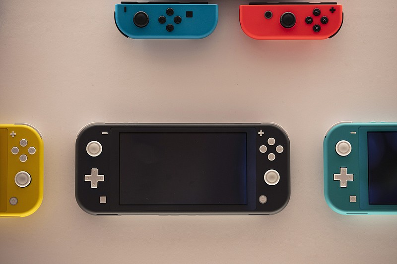 In this Thursday, Jan, 23, 2020 file photo, Nintendo Switch game consoles are on display at Nintendo's official store in the Shibuya district of Tokyo. Time spent playing video games can be good for mental health, according to a new study by researchers at Oxford University. The finding comes as video game sales this year have boomed as more people are stuck at home because of the pandemic and many countries have once again imposed limits on public life. The paper released Monday, NOv. 16, 2020 is based on survey responses from people who played two games, Plants vs Zombies: Battle for Neighborville and Animal Crossing: New Horizons. (AP Photo/Jae C. Hong, File)