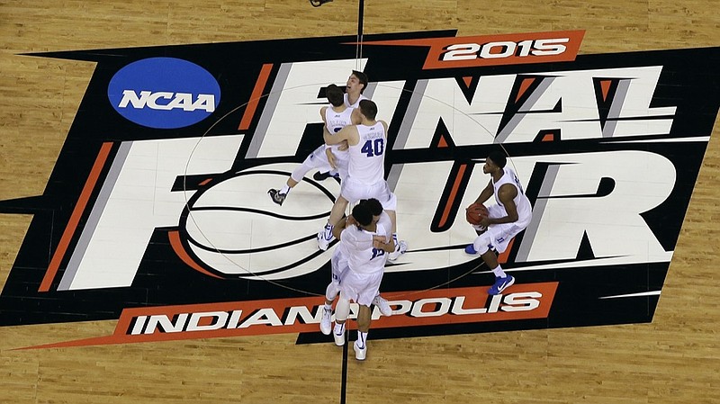 FILE - Duke players celebrate after the NCAA Final Four college basketball tournament championship game against Wisconsin in Indianapolis, in this Monday, April 6, 2015, file photo. The NCAA announced Monday, Nov. 16, 2020, it plans to hold the entire 2021 men's college basketball tournament in one geographic location to mitigate the risks of COVID-19 and is in talks with Indianapolis to be the host city (AP Photo/David J. Phillip, File)