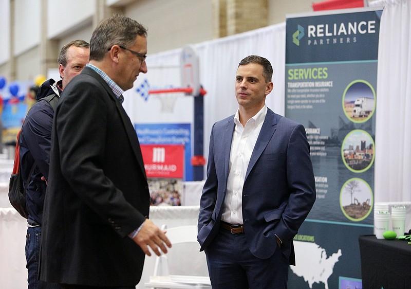 Staff photo by Erin O. Smith / 
Richard Hans and Blake White speaks with Andrew Ladebauche, CEO of Reliance Partners, during the Small Business Awards Luncheon at the Chattanooga Convention Center on Tuesday, Feb. 13, 2018 in Chattanooga, Tenn. Reliance Partners won the Small Business Award for 45-200 employees category. 