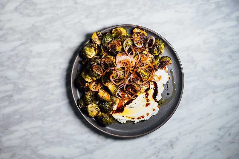 Brussels sprouts, an unfairly maligned vegetable, get an update with creamy labneh and irresistible pickled shallots. / Photo by Nik Sharma/The New York Times