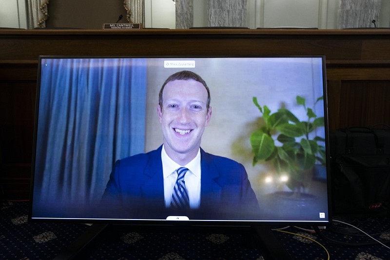 FILE - In this Oct. 28. 2020 file photo, Facebook CEO of Mark Zuckerberg appears on a screen as he speaks remotely during a hearing before the Senate Commerce Committee on Capitol Hill in Washington. (Michael Reynolds/Pool via AP)