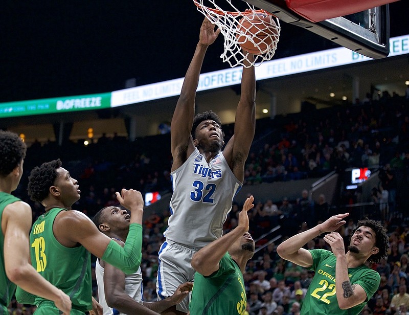 FILE - Memphis center James Wiseman (32) dunks against Oregon during the second half of an NCAA college basketball game in Portland, Ore., in this Tuesday, Nov. 12, 2019, file photo. At long last, James Wiseman is about to be on a team again. More than a year removed from the end of his three-game college career that was doomed almost before it started because of NCAA rulings regarding his eligibility, the 7-foot-1 left-hander will be one of the first players selected in Wednesday's, Nov. 18, 2020, NBA draft. It's hard to envision a scenario where he doesn't go in the first three picks, which are currently held by Minnesota, Golden State and Charlotte.(AP Photo/Craig Mitchelldyer, File)