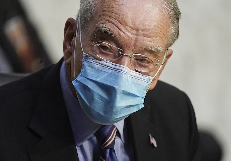 In this Oct. 12, 2020 file photo, Sen. Charles Grassley, R-Iowa, listens during a confirmation hearing for Supreme Court nominee Amy Coney Barrett before the Senate Judiciary Committee, on Capitol Hill in Washington. Grassley, the longest-serving Republican senator, says he is quarantining after being exposed to the coronavirus. Grassley is 87. He did not say how he was exposed. (Kevin Dietsch/Pool via AP)