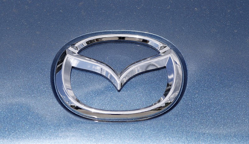 In this June 14, 2020, photograph, a Mazda company logo shines on the front of an unsold 2020 Miata at a Mazda dealership in Littleton, Colo. On Thursday, Nov. 19, Mazda beat traditional winners Lexus and Toyota to win top honors as the most dependable auto brand in Consumer Reports' annual reliability survey. Reports surveyed organization members who own more than 300,000 vehicles from model years 2000 to 2020. (AP Photo/David Zalubowski)