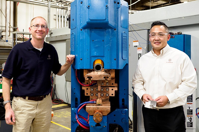 Staff photo by C.B. Schmelter / T.J. Snow Co. CEO Sam Snow, left, and Vince Dang, T. J. Snow's applications sales engineer, check out a piece of resistance spot welding machinery at the Chattanooga company.