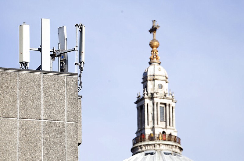 Mobile network phone masts are visible in front of St Paul's Cathedral in the City of London. Dozens of European cell towers have been destroyed in recent arson attacks that officials and wireless companies say are fueled by groundless conspiracy theories linking new 5G mobile networks and the coronavirus pandemic. (AP Photo/Alastair Grant, File)