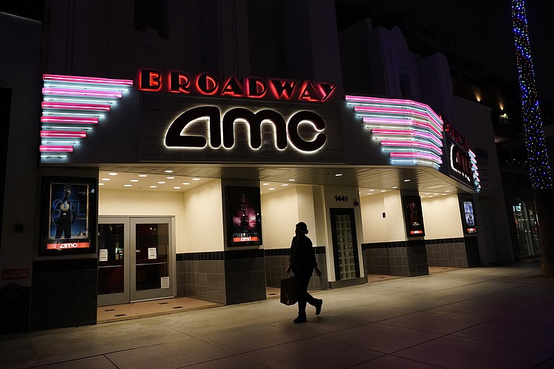 A shopper walks past a closed AMC movie theater Thursday, Nov. 19, 2020, in Santa Monica, Calif. California Gov. Gavin Newsom is imposing an overnight curfew as the most populous state tries to head off a surge in coronavirus cases. On Thursday, Newsom announced a limited stay-at-home order in 41 counties that account for nearly the entire state population of just under 40 million people. (AP Photo/Marcio Jose Sanchez)