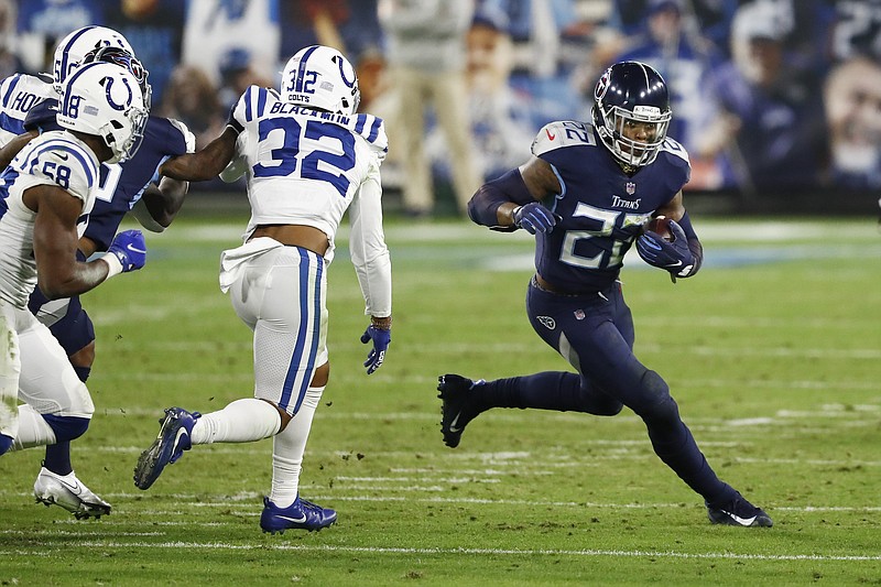 AP photo by Wade Payne / Tennessee Titans running back Derrick Henry, right, carries the ball past Indianapolis Colts free safety Julian Blackmon (32) on Nov. 12 in Nashville.