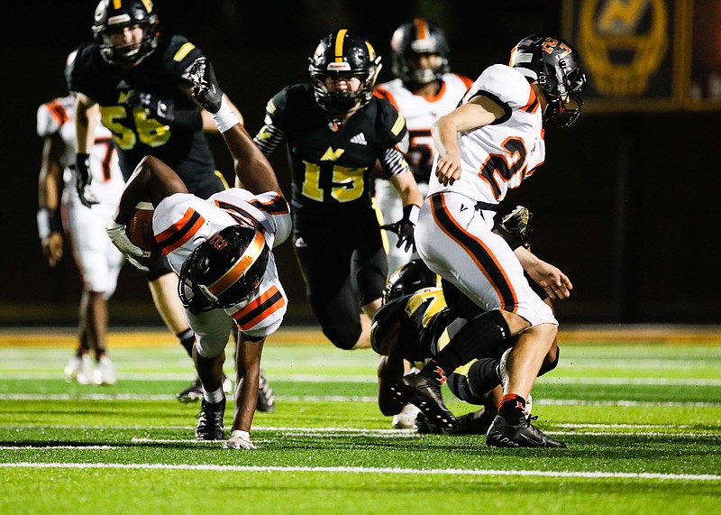 Staff photo by Troy Stolt / Lafayette running back Sam Hall puts his hand down as he fights for extra yards during Friday night's GHSA Region 6-AAA game at North Murray in Chatsworth, Ga.