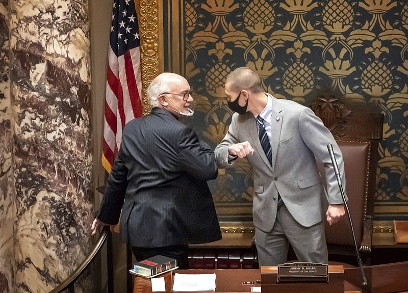 FILE - In this Nov. 12, 2020 file photo, outgoing Minnesota State Senate President Senate President Jeremy Miller, R-Winona gave Sen. David Tomassoni, DFL-Chisholm a congratulatory elbow bump before Tomassoni addressed the Senate Chamber in St. Paul, Minn. At least 187 state legislators nationwide have tested positive for the virus and four have died since the pandemic began, according to figures compiled by The Associated Press. Twelve Arkansas lawmakers have tested positive for the virus over the past month, the second largest known outbreak in a state legislature. (Glen Stubbe/Star Tribune via AP)


