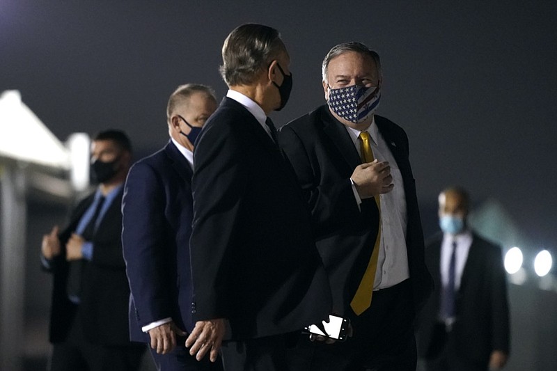 Secretary of State Mike Pompeo, center right, speaks with U.S. Ambassador to the United Arab Emirates John Rakolta before boarding a plane at Al Bateen Executive Airport in Abu Dhabi, United Arab Emirates, Sunday, Nov. 22, 2020. Pompeo is en route to Saudi Arabia. (AP Photo/Patrick Semansky, Pool)