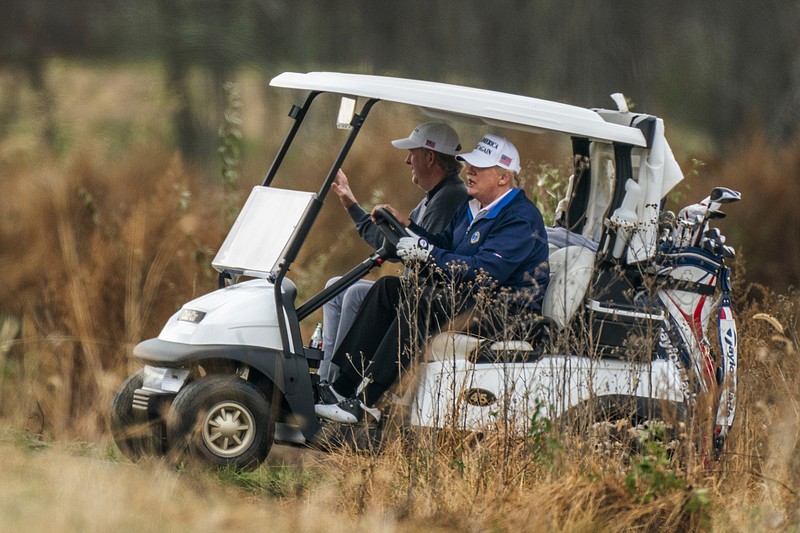 Photo by Manuel Balce Ceneta of The Associated Press / President Donald Trump drives his golf cart as he plays golf at the Trump National Golf Club in Sterling, Virginia, on Sunday, Nov. 22, 2020.