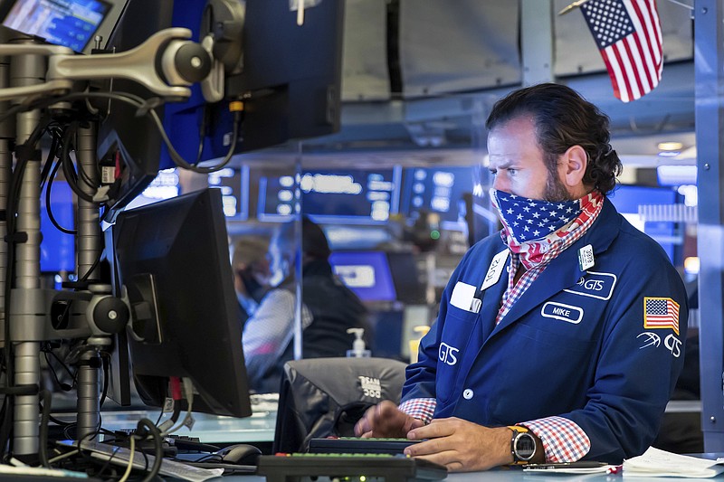 Specialist Michael Pistillo works at the New York Stock Exchange on Monday, Nov. 23, 2020. Stocks rose in early trading Monday after investors received several pieces of encouraging news on COVID-19 vaccines and treatments, tempering concerns over rising virus cases and business restrictions. (Nicole Pereira/New York Stock Exchange via AP)