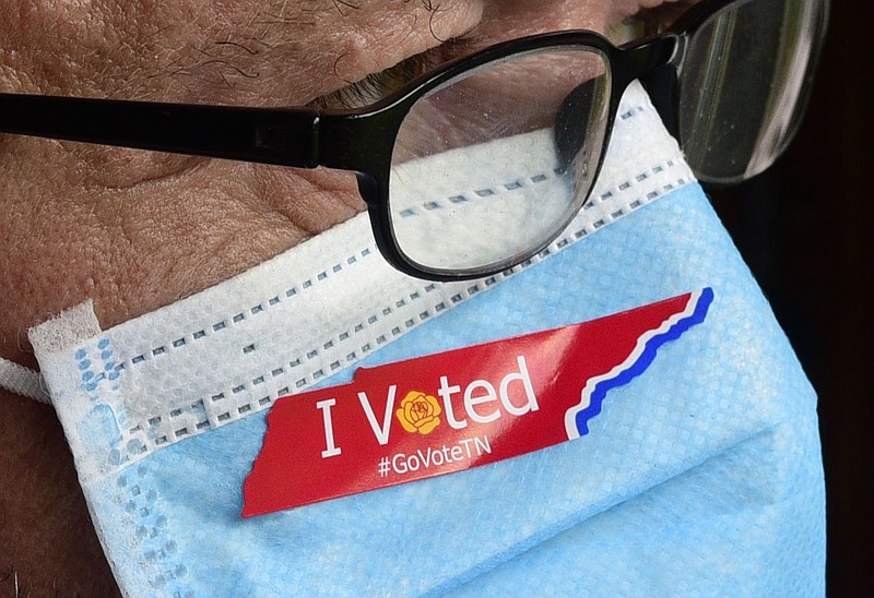 Staff Photo Illustration by Robin Rudd / In this photo illustration a man wears a protective mask with a Tennessee "I Voted" sticker.