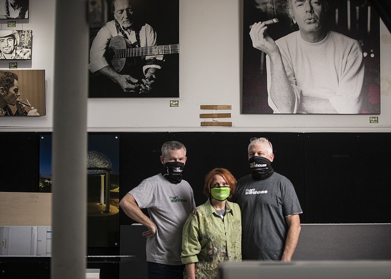 Staff photo by Troy Stolt / Mark, Mitch, and Leslie Lakey inside Art Warehouse on Brainerd Road.