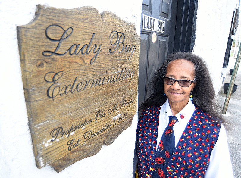 Staff Photo by Matt Hamilton / Ola Phipps stands beside her business plaque on Monday, Oct. 19, 2020 at her office. Ola Phipps opened her own business in 1982 and named it 'Lady Bug" because "everyone called me the "bug lady," so I named it "Lady Bug," she said.