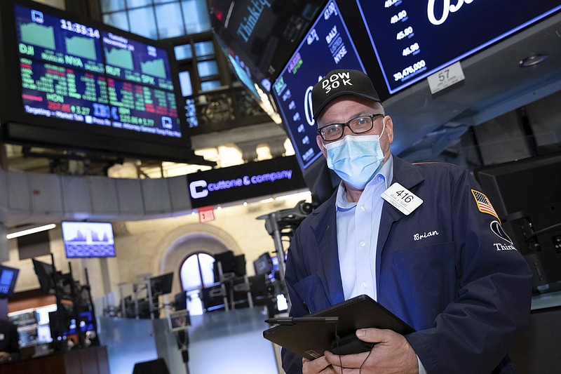 A trader works at the New York Stock Exchange, Tuesday, November 24, 2020. The Dow Jones Industrial Average traded above 30,000 points for the first time as investors were encouraged by the latest progress on developing coronavirus vaccines and news that the transition of power in the U.S. to President-elect Joe Biden will finally begin. (Nicole Pereira/NYSE via AP)