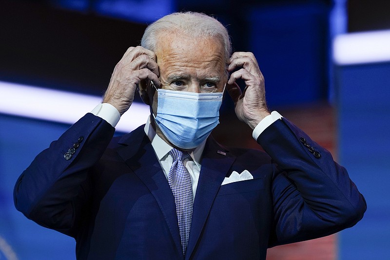 Photo by Carolyn Kaster of The Associated Press / President-elect Joe Biden puts on his face mask after introducing nominees and appointees to key national security and foreign policy posts at The Queen theater on Tuesday, Nov. 24, 2020, in Wilmington, Delaware.